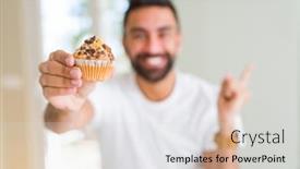  Presentation with muffin - Cool new theme with handsome hispanic man eating chocolate chips muffin very happy pointing with hand and finger to the side backdrop and a light gray colored foreground
