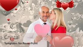  Presentation with kiss - Presentation consisting of handsome man holding paper heart getting a kiss from wife against grey valentines heart pattern background and a soft green colored foreground