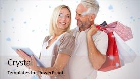  Presentation with falling snow - Beautiful presentation theme featuring happy couple holding shopping bags and looking at tablet pc against snow falling backdrop and a coral colored foreground