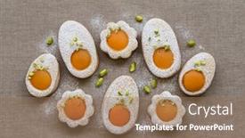  Presentation with apricot - Colorful presentation enhanced with happy easter cookies in the shape of white eggs with apricot yolk with pistachios as homemade decoration for children and fun backdrop and a coral colored foreground