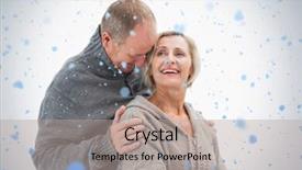  Presentation with falling snow - Beautiful presentation theme featuring happy mature couple in winter clothes against snow falling backdrop and a light gray colored foreground