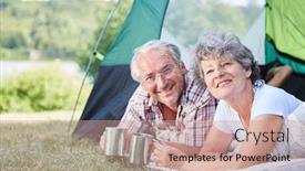  Presentation with campsite - Amazing presentation theme having happy seniors couple relaxing in the summer vacations in the tent at the campsite backdrop and a coral colored foreground