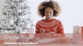  Presentation with christmas presents - Theme with happy young african woman wrapping presents at a table in her living room in front of the decorated christmas tree background and a coral colored foreground