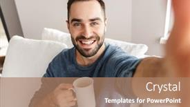  Presentation with selfie - PPT theme having happy young man sitting on a couch at home taking a selfie holding a cup background and a coral colored foreground