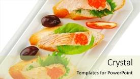  Presentation with caviar - Theme enhanced with healthy appetizer sandwich with sea salmon and red caviar olives tomato and lemon on white china plate isolated over white background background and a blonde colored foreground