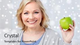  Presentation with healthy diet organic food - Theme consisting of healthy eating organic food fruits diet and people concept - happy middle aged woman with green apple at home over snow background and a lemonade colored foreground