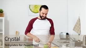  Presentation with young healthy people - Presentation theme consisting of healthy eating vegetarian food diet and people concept - happy young man with blender and fruits cooking at home kitchen background and a mint green colored foreground