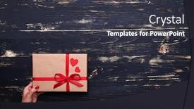 Presentation with gift ribbon - PPT theme with high angle of the hand holds nice gift box wrapped with red ribbon isolated over grunge wooden flat lay background background and a dark gray colored foreground