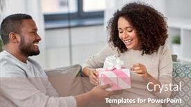  Presentation with happy-holiday - Colorful presentation theme enhanced with holiday greeting and people concept - happy african american couple with gift at home backdrop and a coral colored foreground