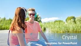  Presentation with teenage love - Theme with holidays vacation love and people concept - happy teenage couple with earphones sitting on river berth and listening to music at summer background and a teal colored foreground