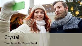  Presentation with christmas holidays - Presentation design consisting of holidays winter christmas technology and people concept - happy couple of tourists in warm clothes taking selfie with smartphone in old town background and a light gray colored foreground