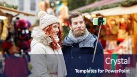  Presentation with old clothes - PPT theme consisting of holidays winter christmas technology and people concept - happy couple of tourists in warm clothes taking picture with smartphone selfie stick in old town background and a navy blue colored foreground