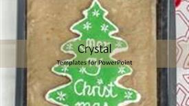  Presentation with christmas baking - PPT theme enhanced with home-made christmas tree-like gingerbread cookie with green icing and merry christmas writing on baking tray background and a coral colored foreground