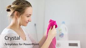 Presentation with garments - Audience pleasing PPT theme consisting of housework young woman doing laundry - putting colorful garments into the washing machine shallow dof color toned image backdrop and a soft green colored foreground
