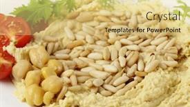  Presentation with dip - Theme with hummus and lightly roasted pine-nuts dip garnished with cherry tomatoes and young salad leaves viewed close-up background and a yellow colored foreground