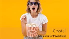  Presentation with popcorn movie - Presentation design having image of shocked blond woman in 3d glasses holding popcorn bucket while watching movie isolated over yellow background background and a gold colored foreground