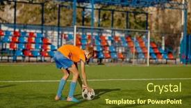  Presentation with penalty - PPT theme enhanced with junior-football-player-placing-ball background and a tawny brown colored foreground