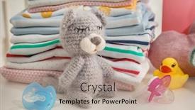  Presentation with knitted clothes - Cool new theme with knitted toy bear and baby clothes on table backdrop and a mint green colored foreground