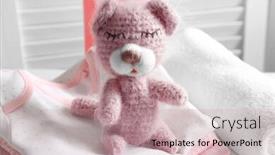  Presentation with knitted clothes - Slide deck enhanced with knitted toy bear on stack of baby clothes background and a coral colored foreground