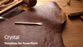  Presentation with hide - Amazing PPT theme having leather craftmans work desk piece of hide and lacing hole punch on a work table backdrop and a violet colored foreground