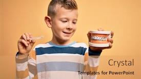  Presentation with orthodontic - Presentation theme having little-kid-boy-holding-professional background and a coral colored foreground