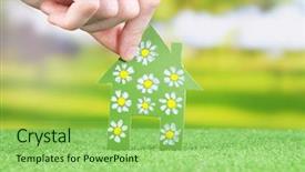  Presentation with green house - Cool new slide deck with little paper house in hand on green grass on bright background backdrop and a seafoam green colored foreground