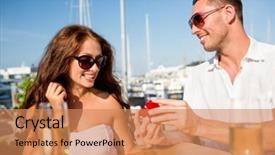  Presentation with dating - Amazing presentation having love dating people and holidays concept - smiling couple wearing sunglasses with champagne and small red gift box looking to each other at cafe backdrop and a coral colored foreground