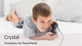  Presentation with what is video gaming - Audience pleasing PPT layouts consisting of lying on bed playing video backdrop and a light gray colored foreground