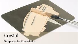  Presentation with foundation - Audience pleasing PPT theme consisting of makeup foundation and spatula on metal palette backdrop and a soft green colored foreground