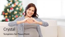  Presentation with pregnancy medicine healthcare and people - Colorful theme enhanced with making heart gesture over christmas backdrop and a soft green colored foreground