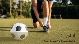  Presentation with soccer - Presentation theme consisting of male soccer player ties his shoelaces on boots background and a tawny brown colored foreground