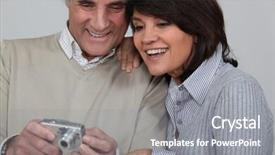  Presentation with married couple - Amazing theme having married couple looking at photographs taken on digital camera backdrop and a gray colored foreground