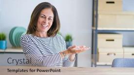  Presentation with woman hands open - PPT theme consisting of middle age senior woman sitting at the table at home pointing aside with hands open palms showing copy space presenting advertisement smiling excited happy background and a mint green colored foreground