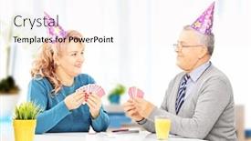  Presentation with playing cards - Slide set consisting of middle aged couple with party hats sitting on table and playing cards at home background and a white colored foreground