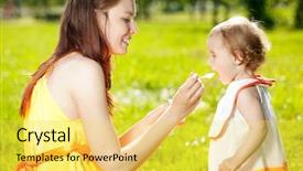  Presentation with baby girl - PPT theme enhanced with mom feeding child - mother feeds baby girl outdoors background and a yellow colored foreground