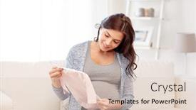  Presentation with motherhood - Audience pleasing slides consisting of motherhood pregnancy people and kids clothing concept - happy woman holding and looking at pink baby girls bodysuit at home backdrop and a lemonade colored foreground