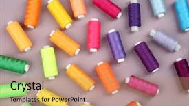  Presentation with sewing tools - Colorful theme enhanced with multicolor sewing threads on wooden backdrop and a coral colored foreground