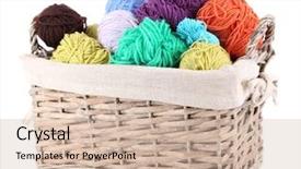  Presentation with yarn - Colorful slides enhanced with multicoloured knitting yarn in basket isolated on white backdrop and a soft green colored foreground