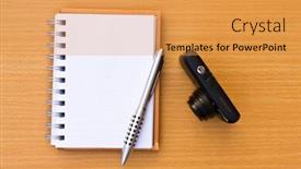  Presentation with note book - Theme having note book and pen and camera on the floor of the wooden table background and a yellow colored foreground