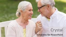  Presentation with relationship - Presentation having old age relationship and people concept - happy senior couple sitting on bench at summer park background and a soft green colored foreground