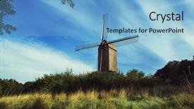  Presentation with old windmill - Theme having old belgian windmill standing on the summer meadow against blue sky background and a light blue colored foreground