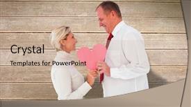  Presentation with older couple - Theme with older affectionate couple holding pink heart shape against wooden surface with planks background and a coral colored foreground
