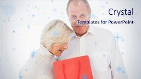  Presentation with older couple - Slides having older couple holding red gift bag against snow falling background and a sky blue colored foreground