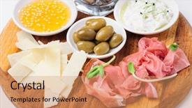  Presentation with shades of olive green - Colorful theme enhanced with olice - assorted cheeses wallnuts prosciutto green backdrop and a  colored foreground