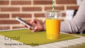  Presentation with fast food - Cool new theme with orange juice in fast food closed cup with tube and mobile phone on wooden table and brick wall background backdrop and a yellow colored foreground