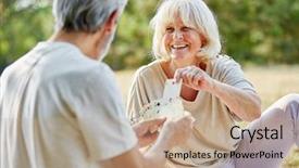  Presentation with deck of playing cards - PPT theme enhanced with outdoor games - happy senior couple playing cards background and a coral colored foreground