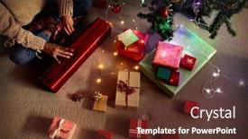  Presentation with christmas presents - PPT layouts having overhead view of a mixed race woman in her sitting room at christmas sitting on a floor and wrapping presents background and a tawny brown colored foreground