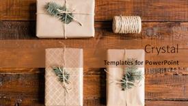  Presentation with bound - Colorful slide set enhanced with overview of three packed wrapped and bound giftboxes with conifer on top and spool of threads on wooden table backdrop and a red colored foreground