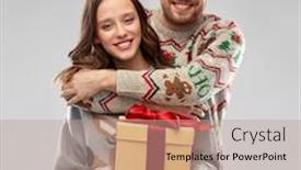  Presentation with ugly christmas sweater - Audience pleasing theme consisting of people and holidays concept - portrait of happy couple with christmas gift at ugly sweater party backdrop and a coral colored foreground