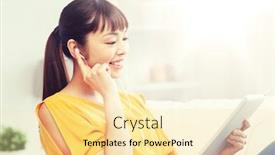  Presentation with computer music - Cool new slide deck with people technology and leisure concept - happy asian young woman sitting on sofa with tablet pc computer and earphones listening to music at home backdrop and a blonde colored foreground